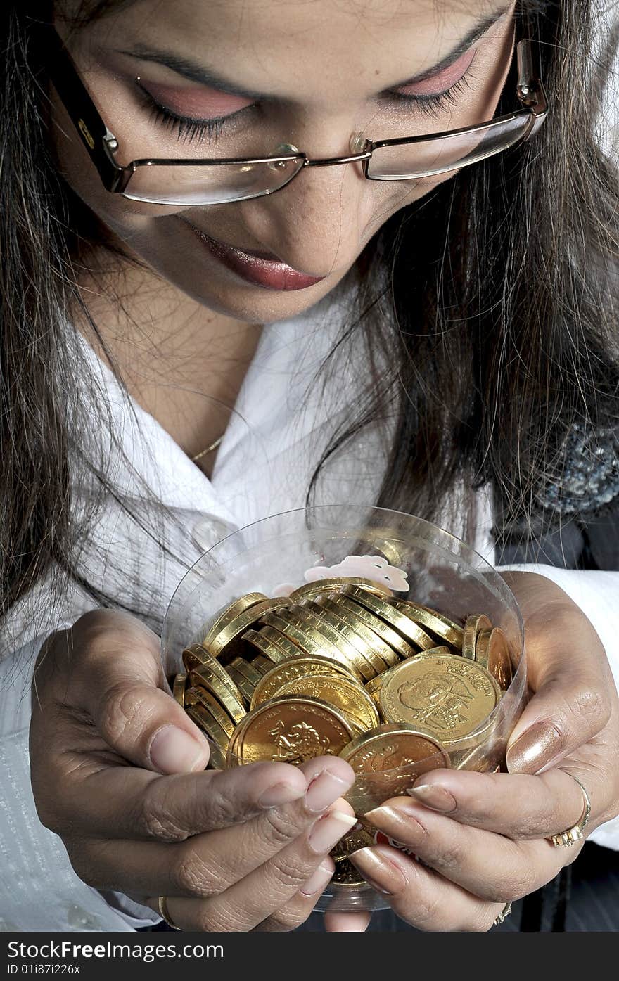 Girl with gold coins in studio.