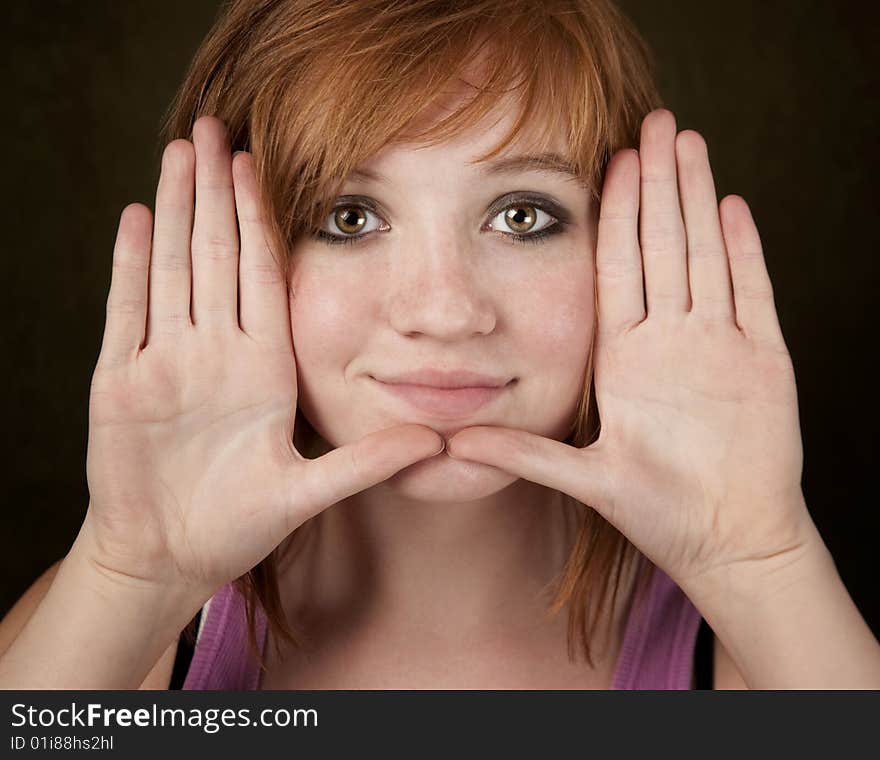 Pretty teenager framing her face with hands