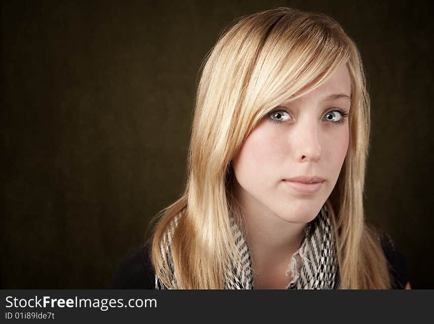 Close up of blonde girl focusing on her blue eyes. Close up of blonde girl focusing on her blue eyes