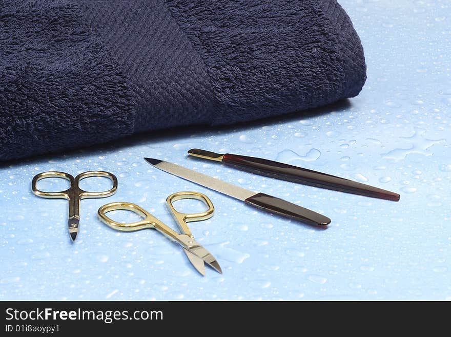 Manicure utensils over blue background