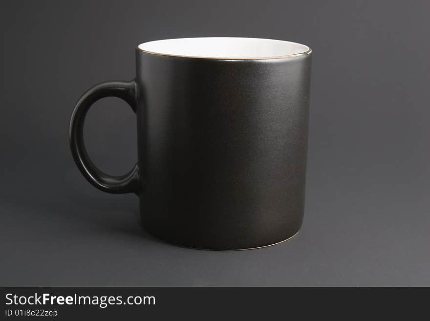 Dark office life: usual black coffee mug isolated on grey