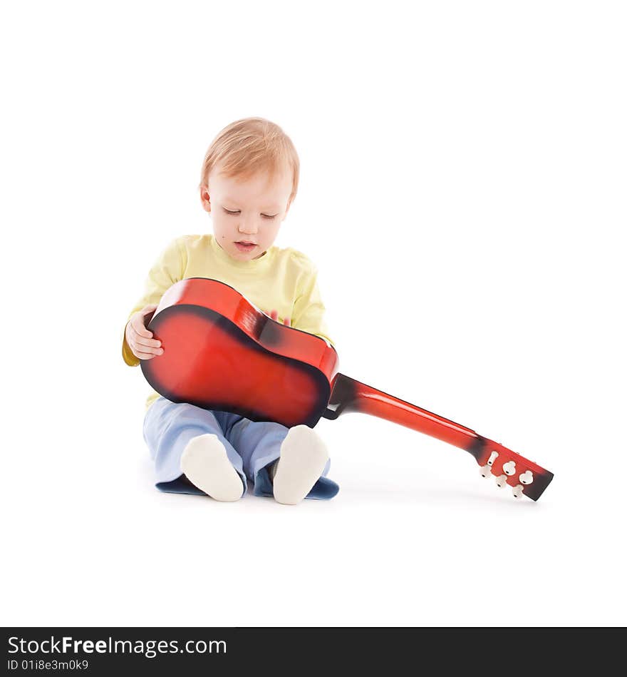 Portrait of the little boy with acoustic guitar