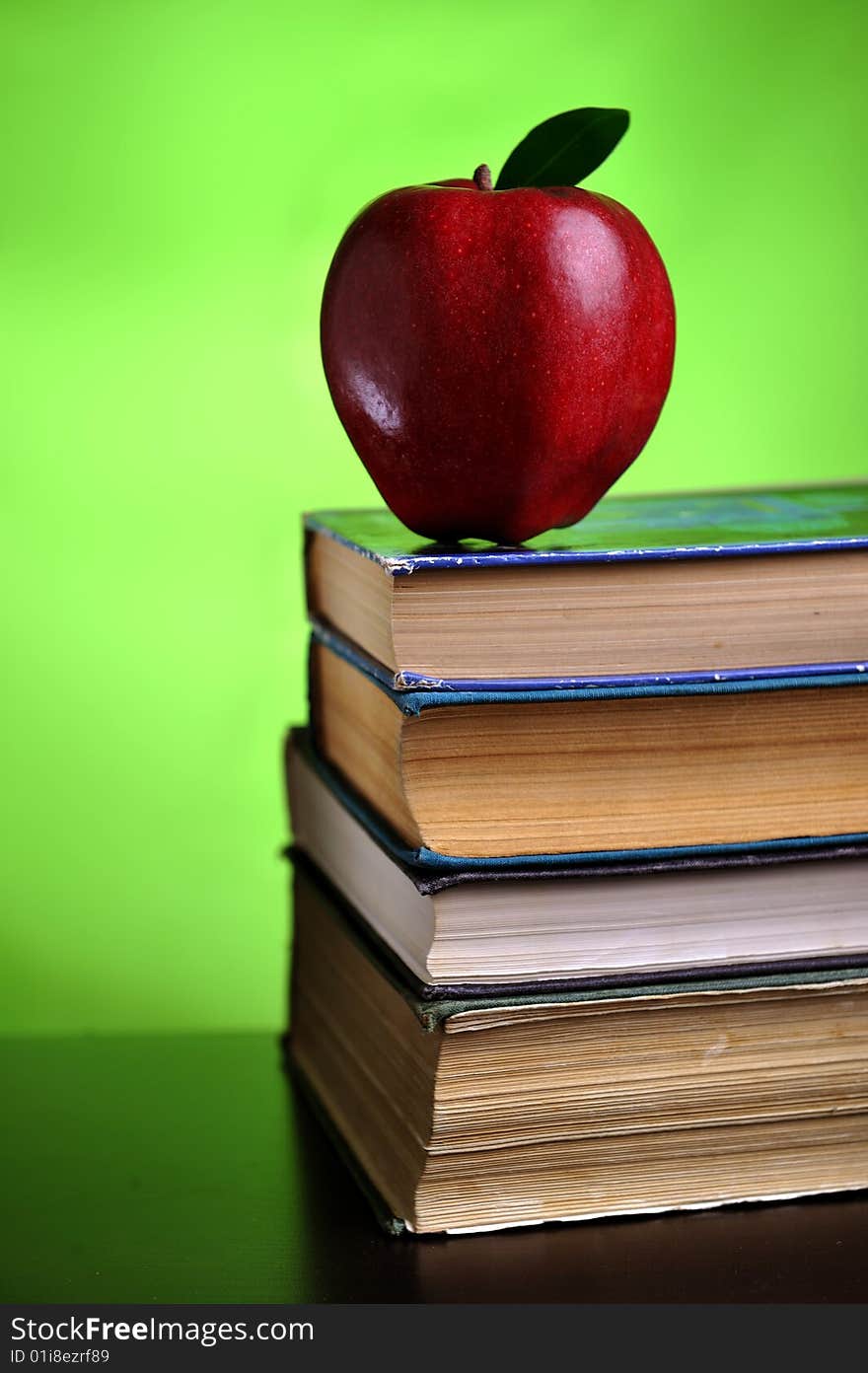 Stack of books with red apple, close up. Stack of books with red apple, close up