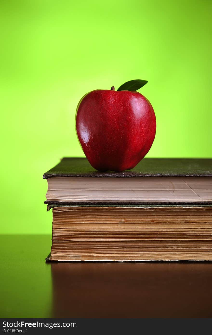 Stack of books with red apple, close up. Stack of books with red apple, close up