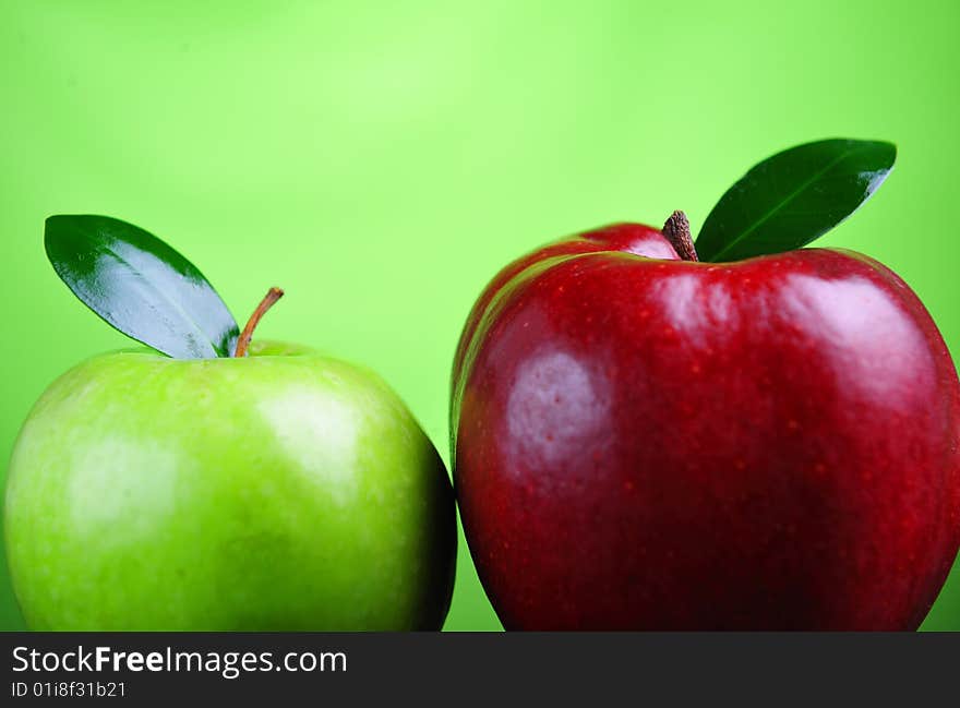 Close up of red and green apple on green background. Close up of red and green apple on green background