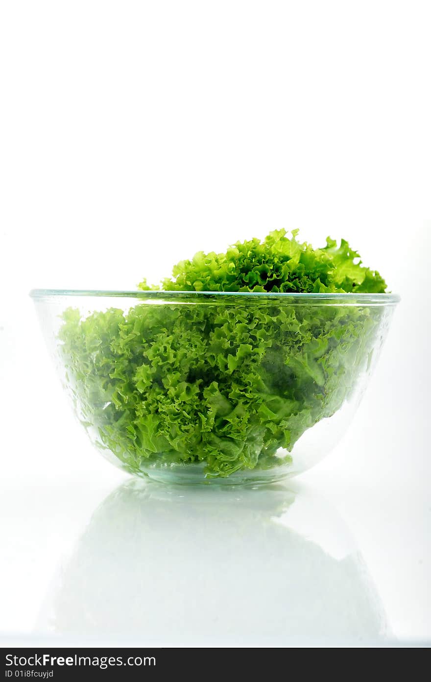 Green salad in a bowl on white background