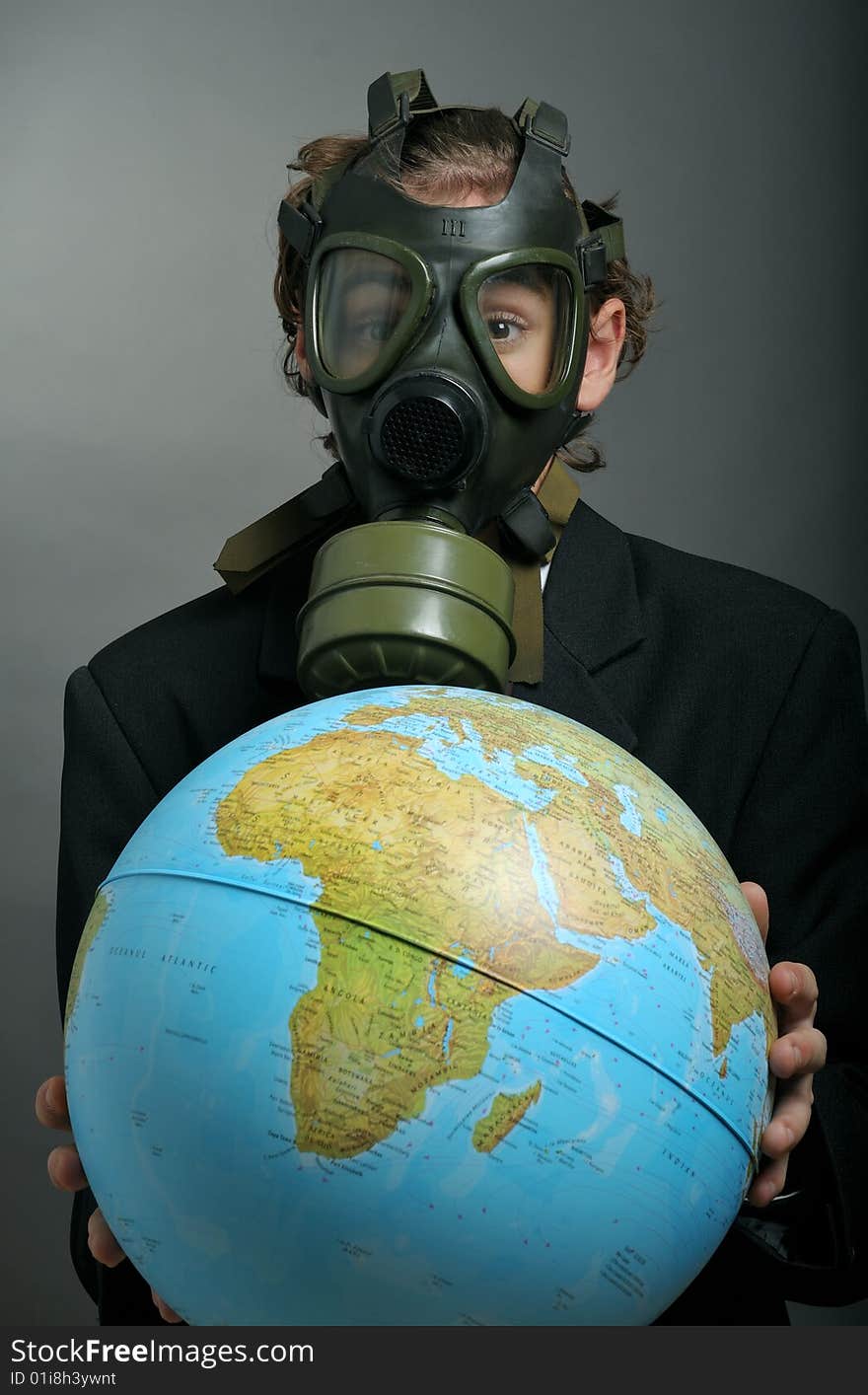 Businessman with gas mask on face holding earth globe. Businessman with gas mask on face holding earth globe