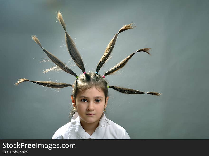 Little girl portrait with six hair plaits rised up. Little girl portrait with six hair plaits rised up