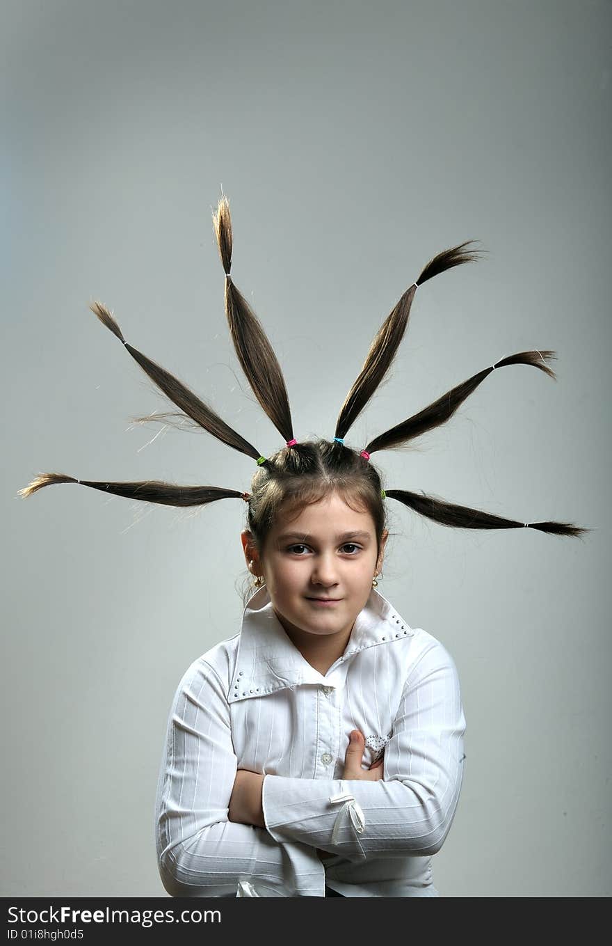 Little girl portrait with six hair plaits rised up. Little girl portrait with six hair plaits rised up