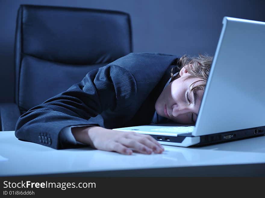 Businessman sleeping on desk near by computer laptop. Businessman sleeping on desk near by computer laptop