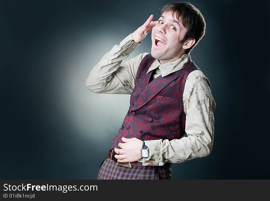 Funny laughing young man, studio shot