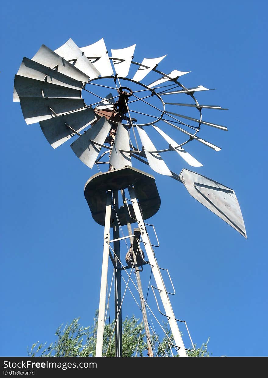 A windmill for pumping water in the country. A windmill for pumping water in the country