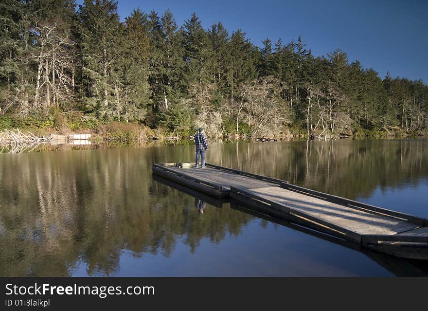 A fisherman at Oregon's Coffenbury Lake pauses to survey the scenery. A fisherman at Oregon's Coffenbury Lake pauses to survey the scenery