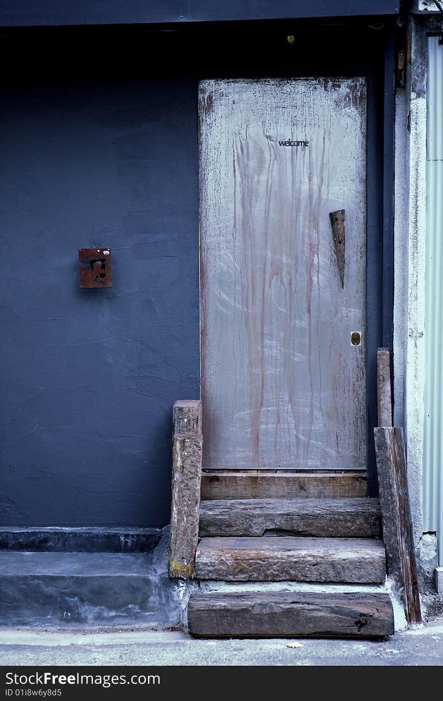 Blue wooden door with stairs part of a building, home or office related

. Blue wooden door with stairs part of a building, home or office related