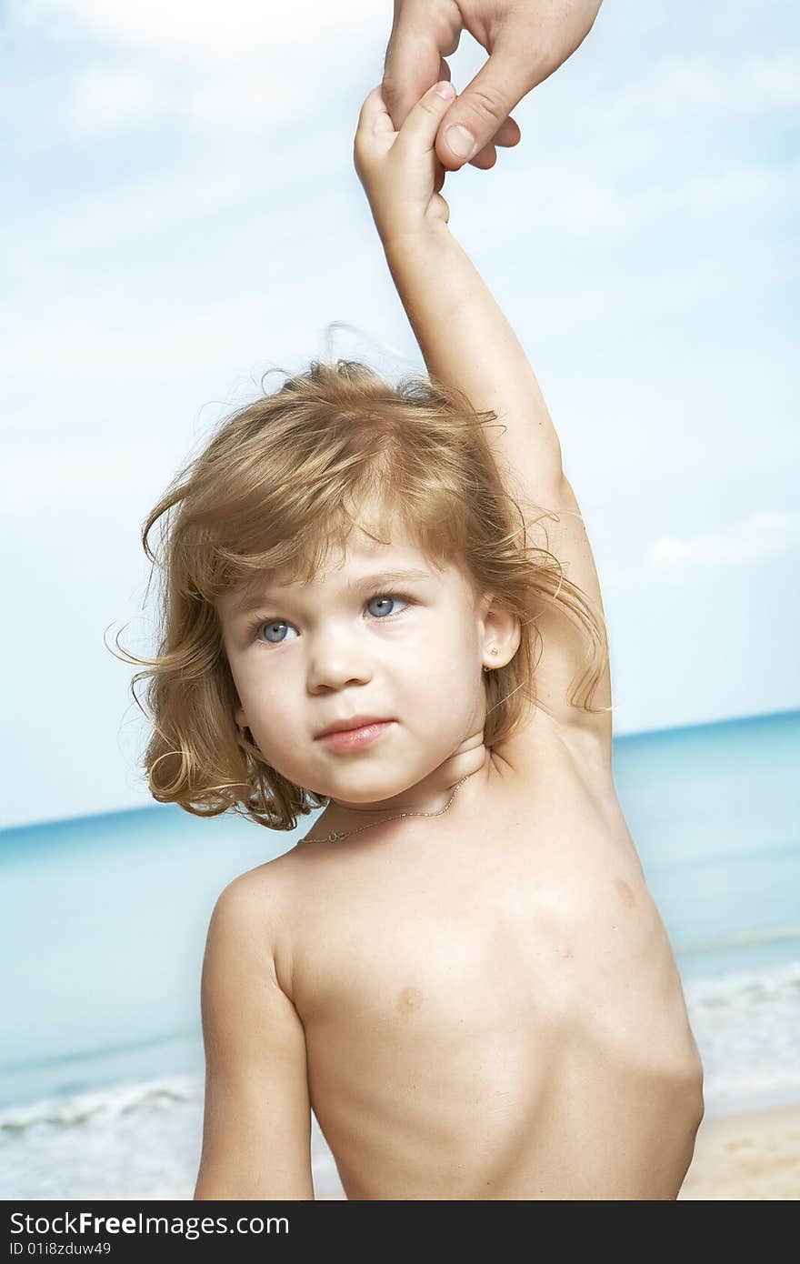 Portrait of nice little girl led by finger around the beach. Portrait of nice little girl led by finger around the beach