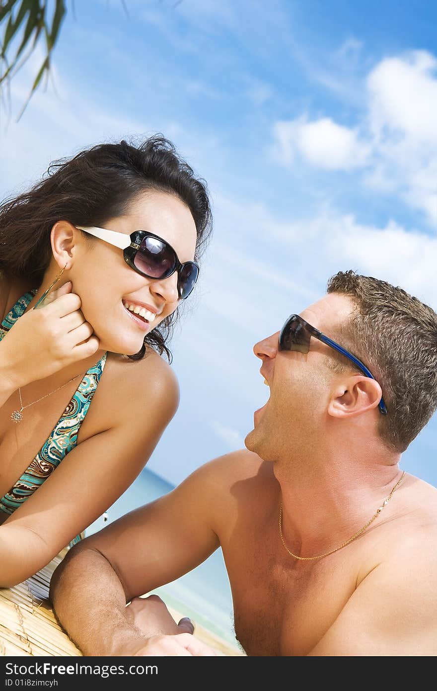 A portrait of attractive couple having fun on the beach. A portrait of attractive couple having fun on the beach