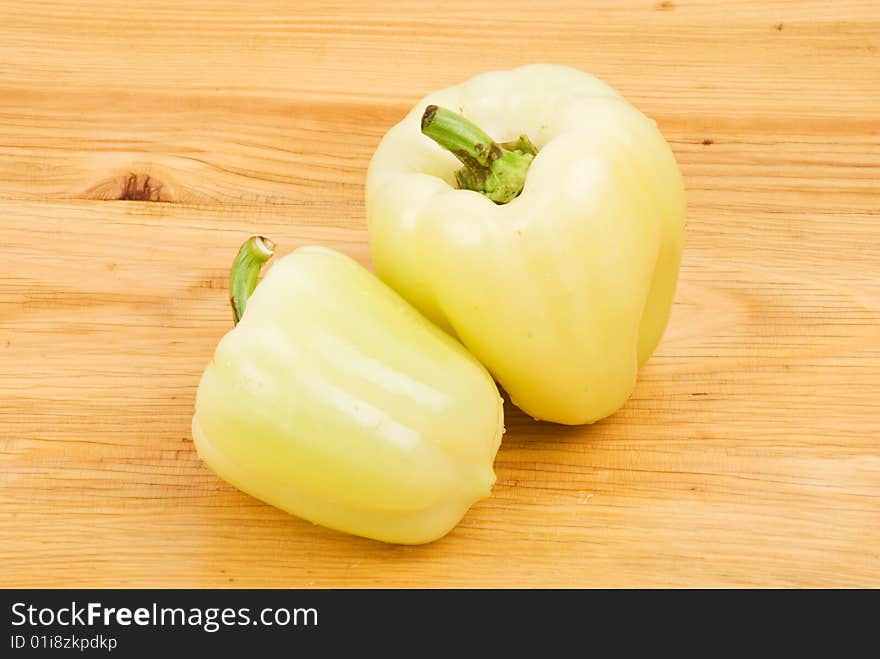 Two green light capsicum on a wood table,check also <a href=http://www.dreamstime.com/healthy-food-rcollection8217-resi828293>Healthy food</a>