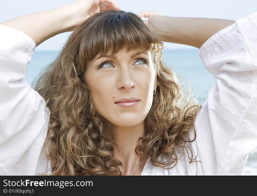 Portrait of nice young woman having good time on the beach. Portrait of nice young woman having good time on the beach