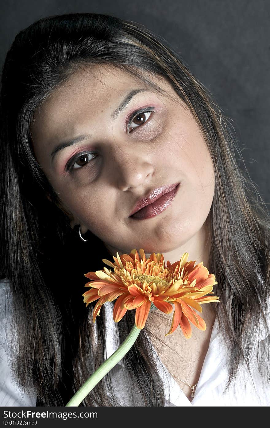 Girl with flower in studio.