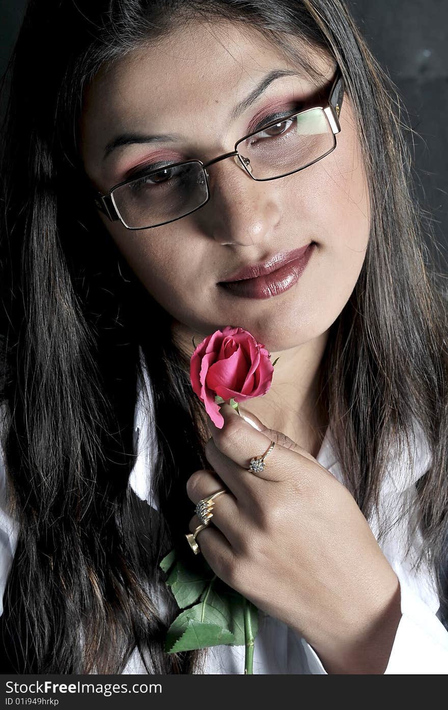 Girl with rose in studio.