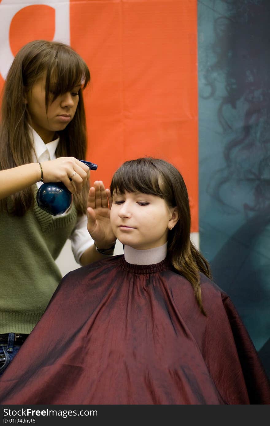 Female-hairdresser doing clients hair in beauty salon. Female-hairdresser doing clients hair in beauty salon