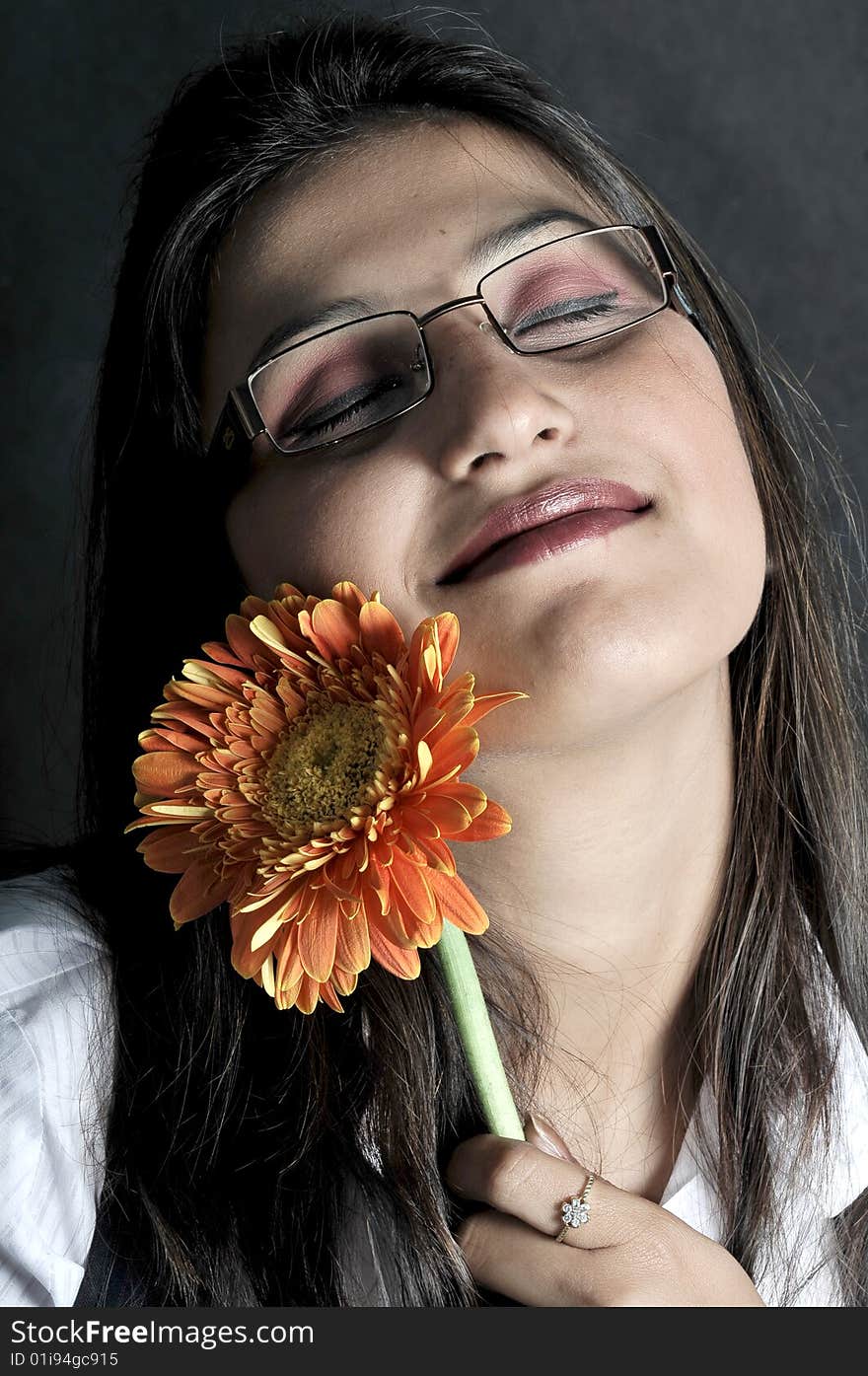 Girl with flower in studio.