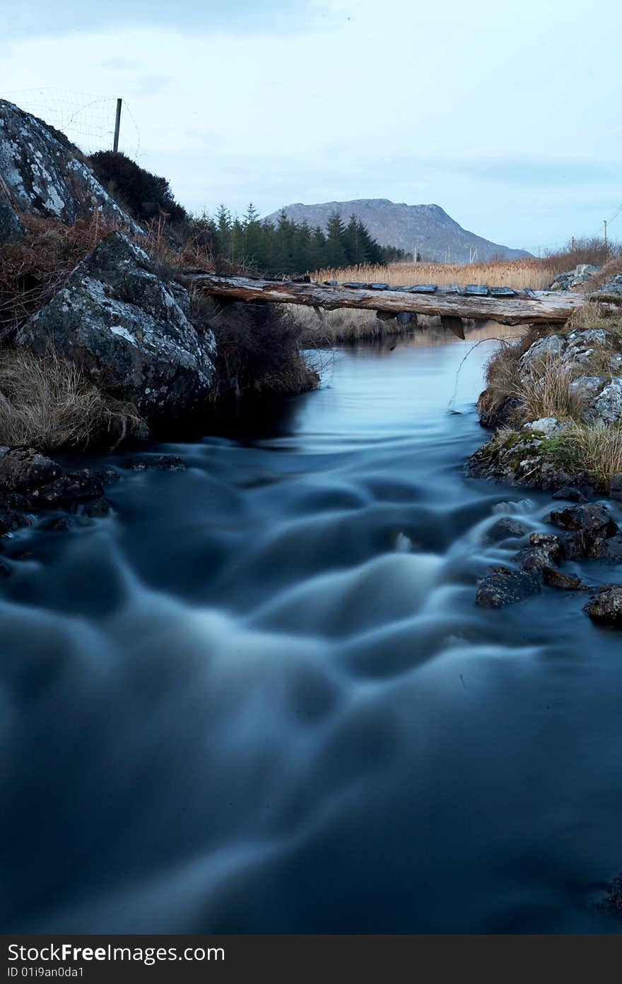 A cascading river with a wooden bridge. A cascading river with a wooden bridge