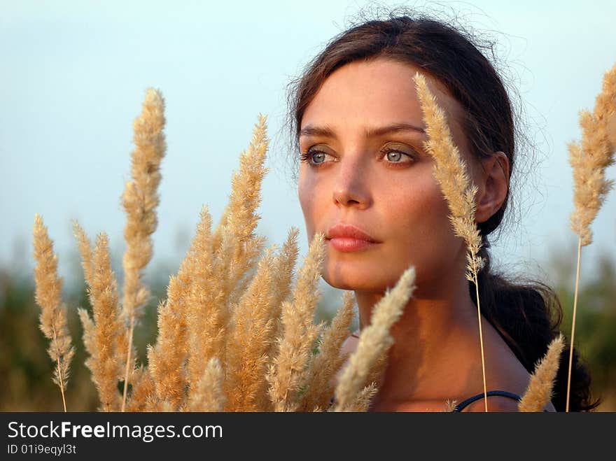 Portrait of woman against the backdrop of cauliflowers reed. Portrait of woman against the backdrop of cauliflowers reed