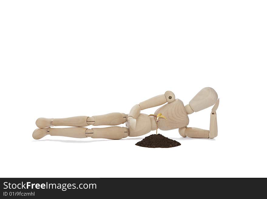 Wooden man lying with small tree. Wooden man lying with small tree