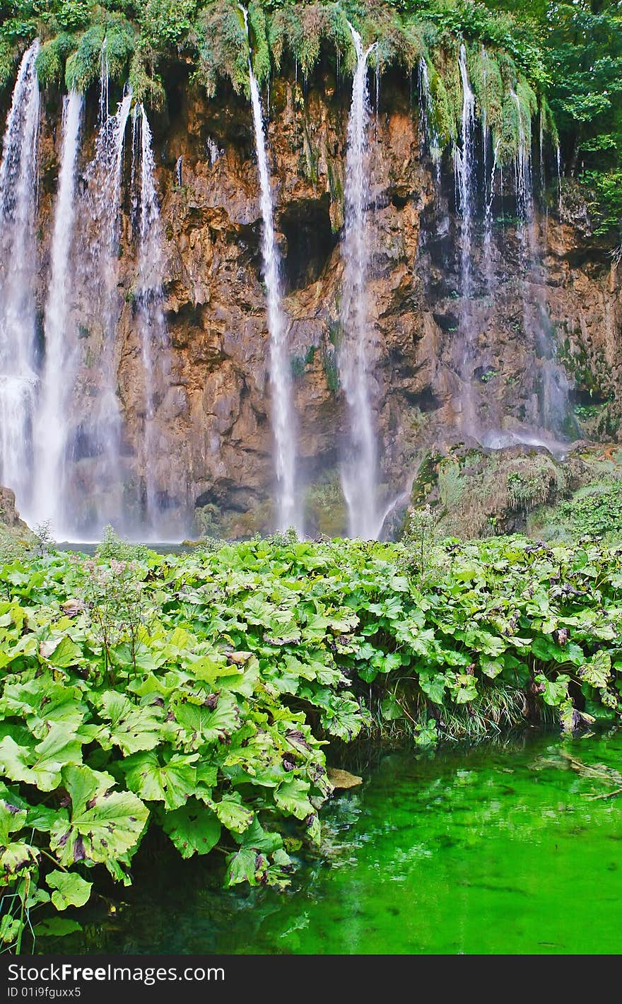 Beautiful waterfall and lake with green water