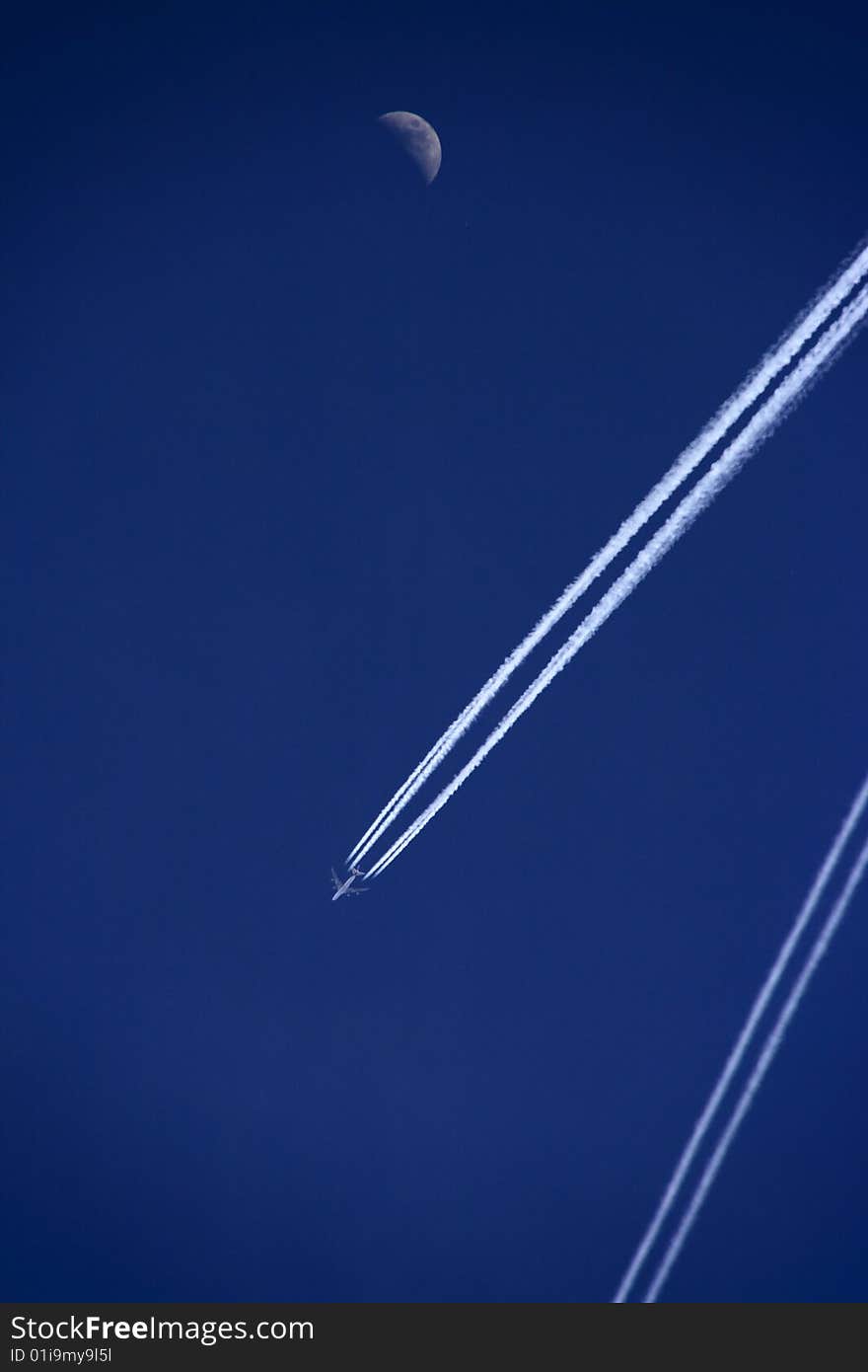 Aeroplane with track against deep blue sky