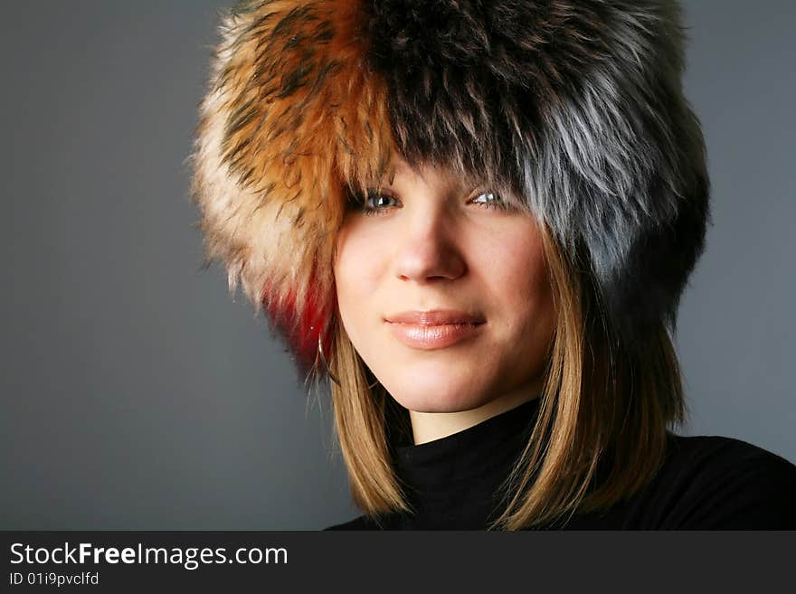 Portrait of a beautiful woman in a fur hat