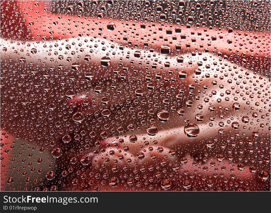 Abstract background with holding hands under glass with raindrops.