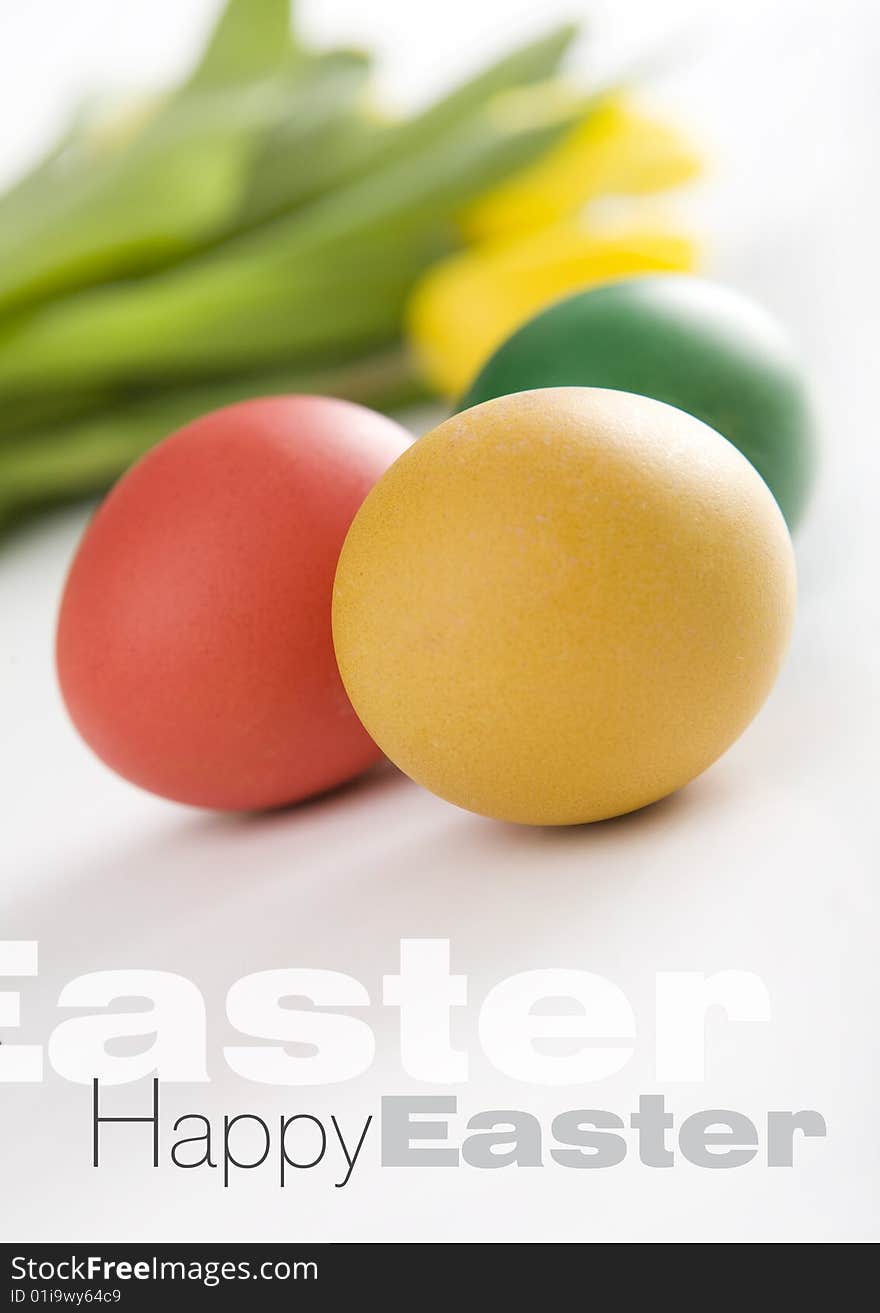 Colorful easter eggs and yellow tulips