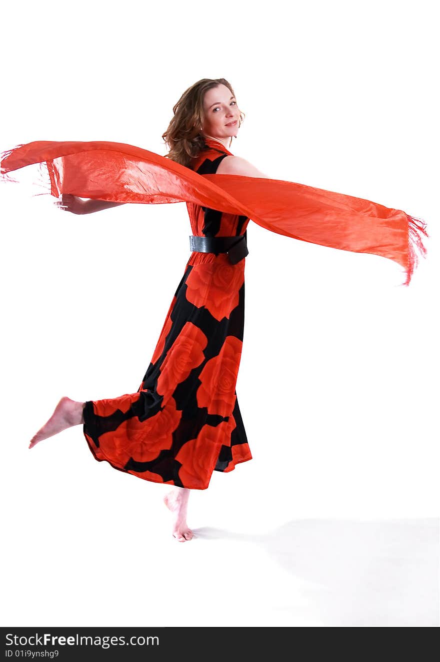 Attractive girl in a slinky red dress is dancing barefoot, isolated on white background. Attractive girl in a slinky red dress is dancing barefoot, isolated on white background.