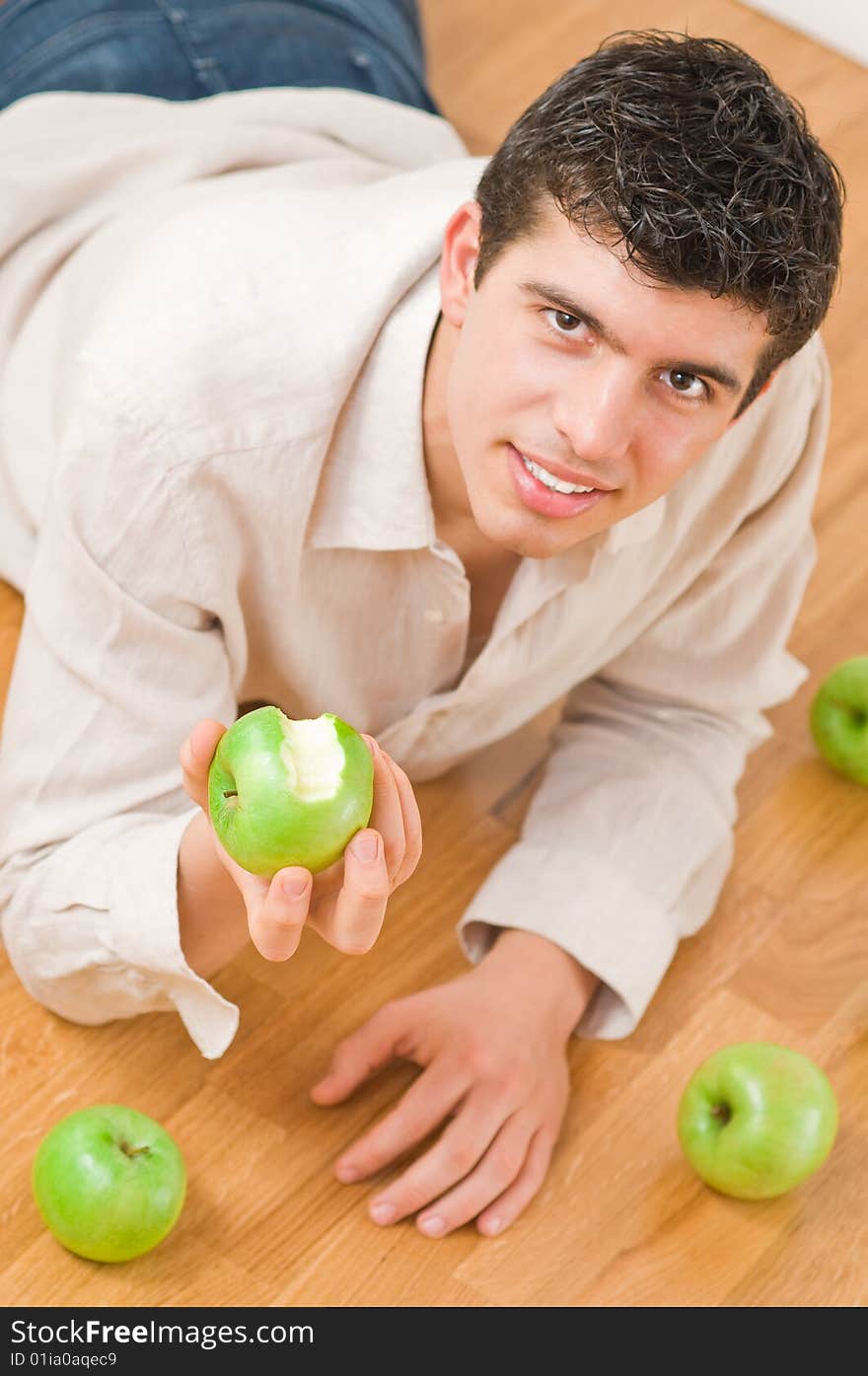 Young man eating green and healthy apples. Young man eating green and healthy apples