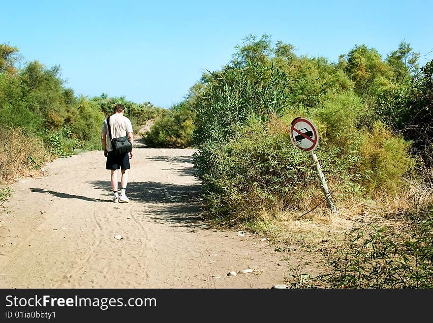 Walking along the sand road. Walking along the sand road