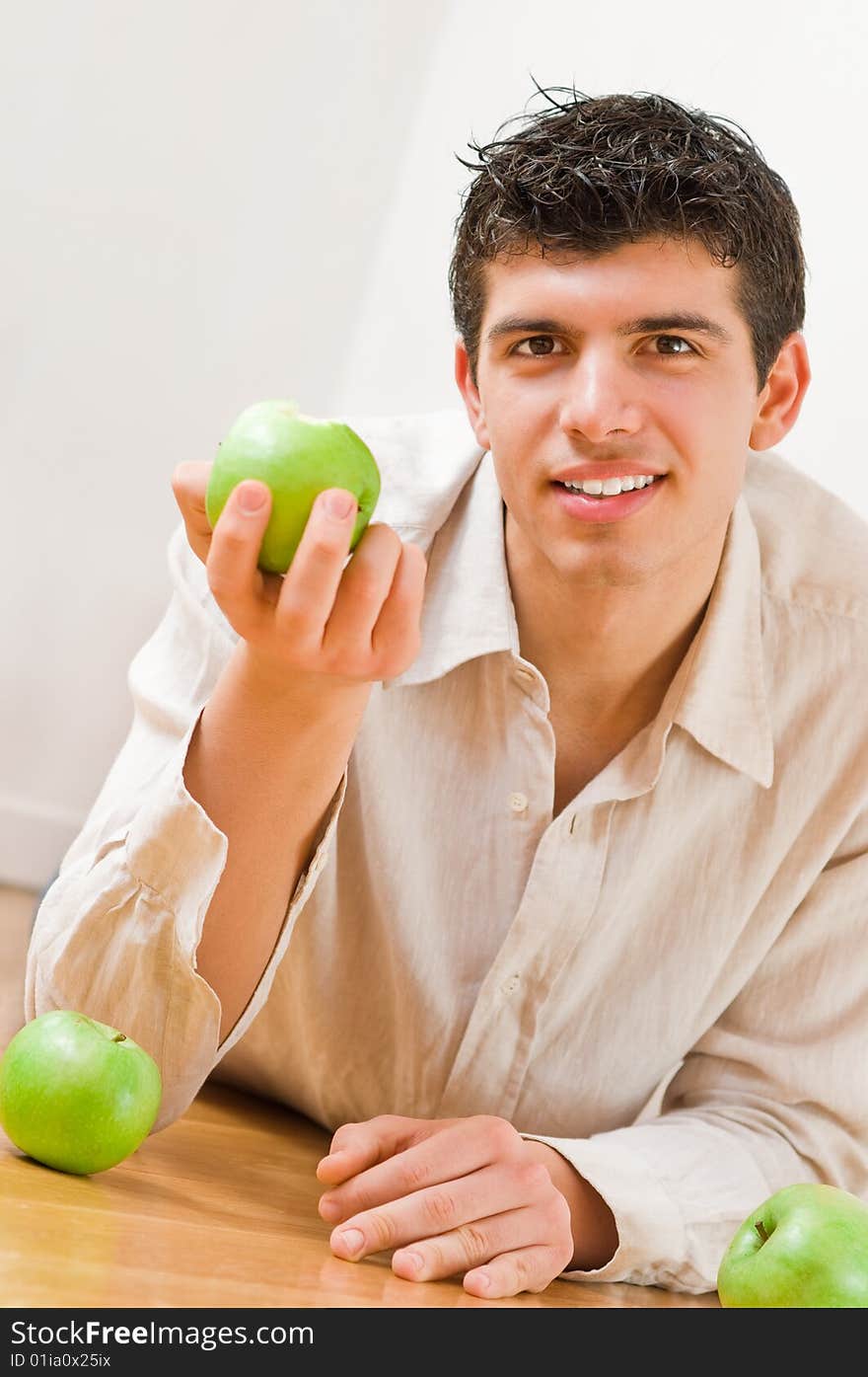 Young man eating green and healthy apples. Young man eating green and healthy apples