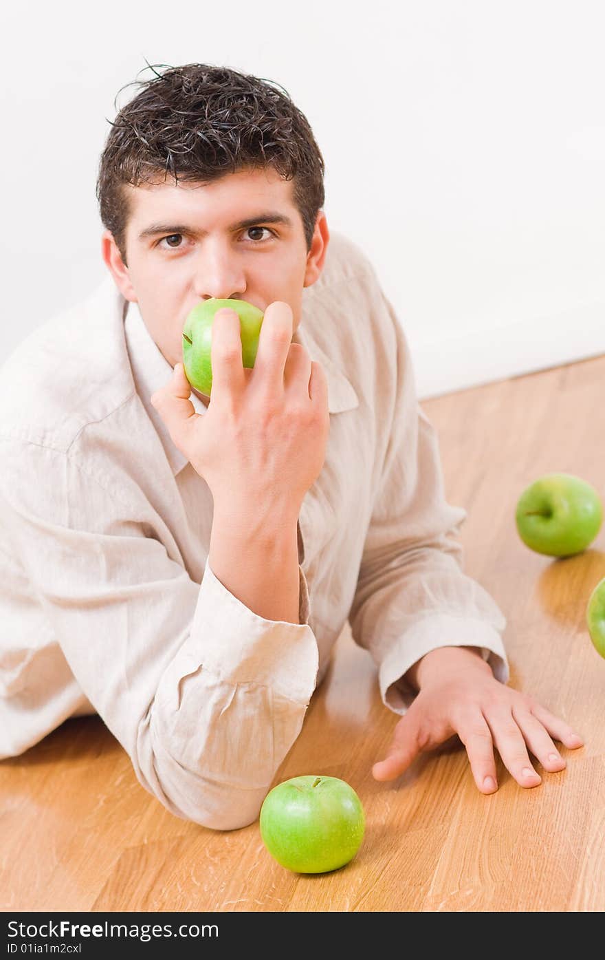 Young man eating green and healthy apples. Young man eating green and healthy apples