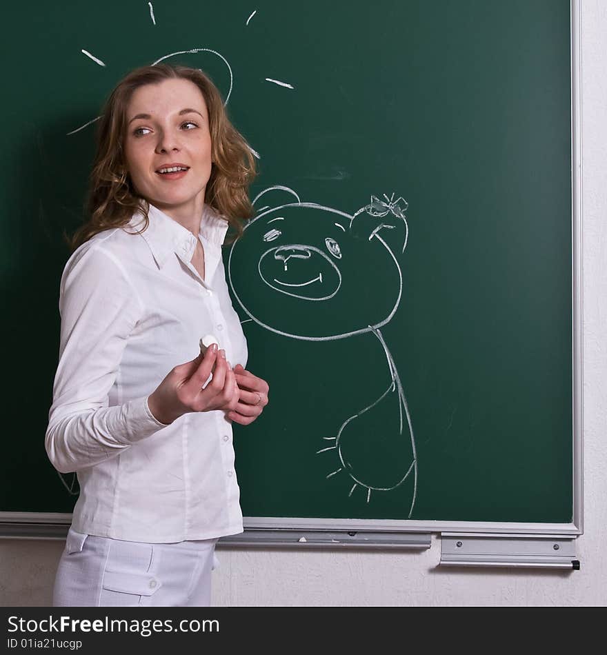 Young Woman Is Drawing On Blackboard.