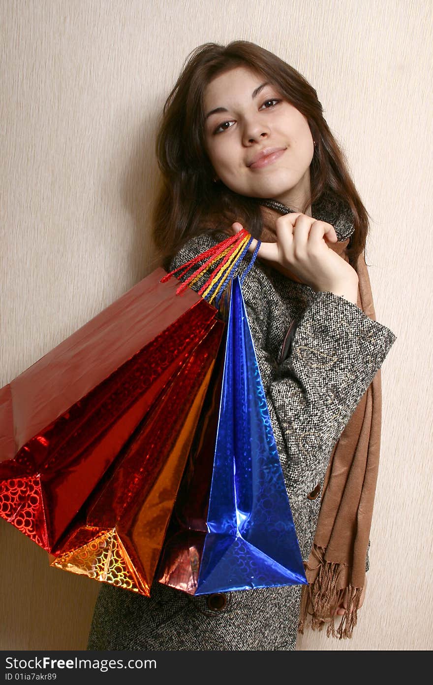 Portrait of the girl with color packages in hands. Portrait of the girl with color packages in hands.