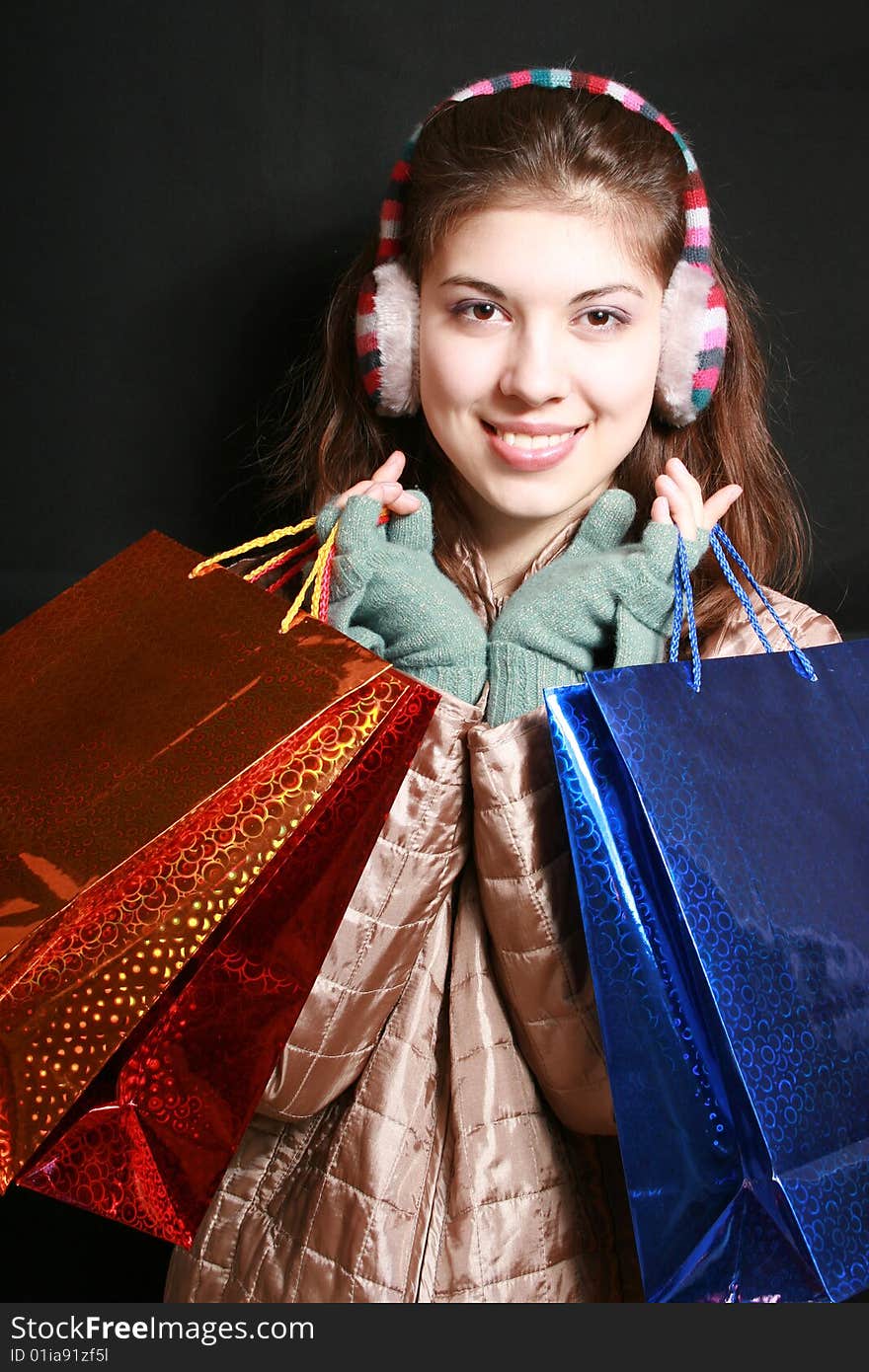 Portrait of the girl with color packages in hands. Portrait of the girl with color packages in hands.