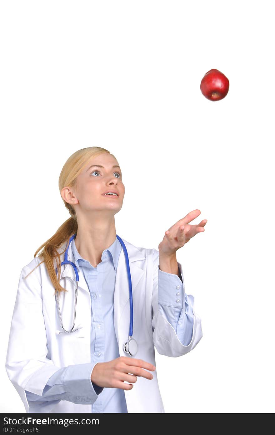 Female medical student tossing up an apple