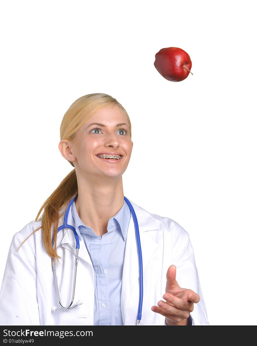 Female medical student tossing up an apple