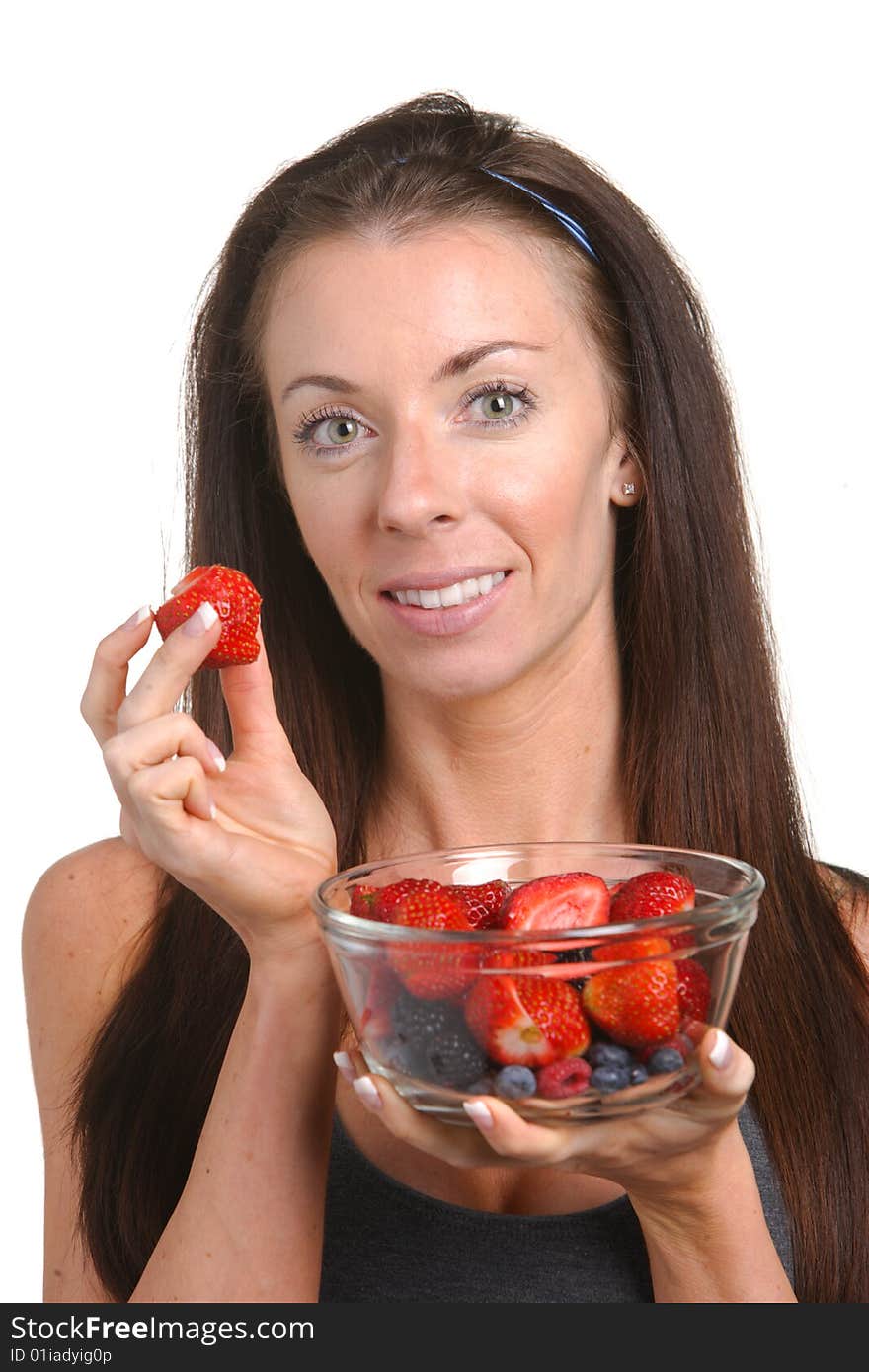 Fitness woman eating fresh fruit isolated on white