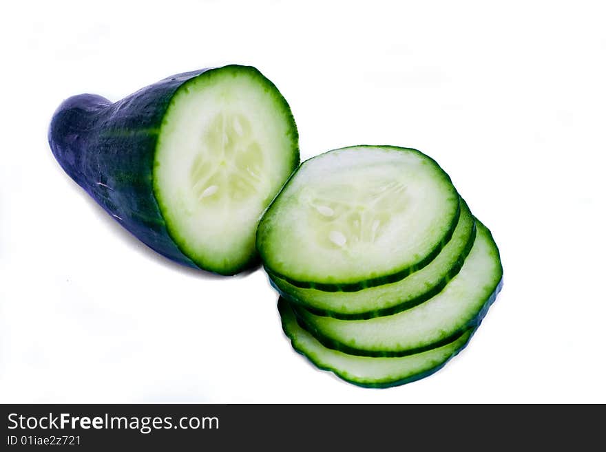 A fresh cucumber with slices over white