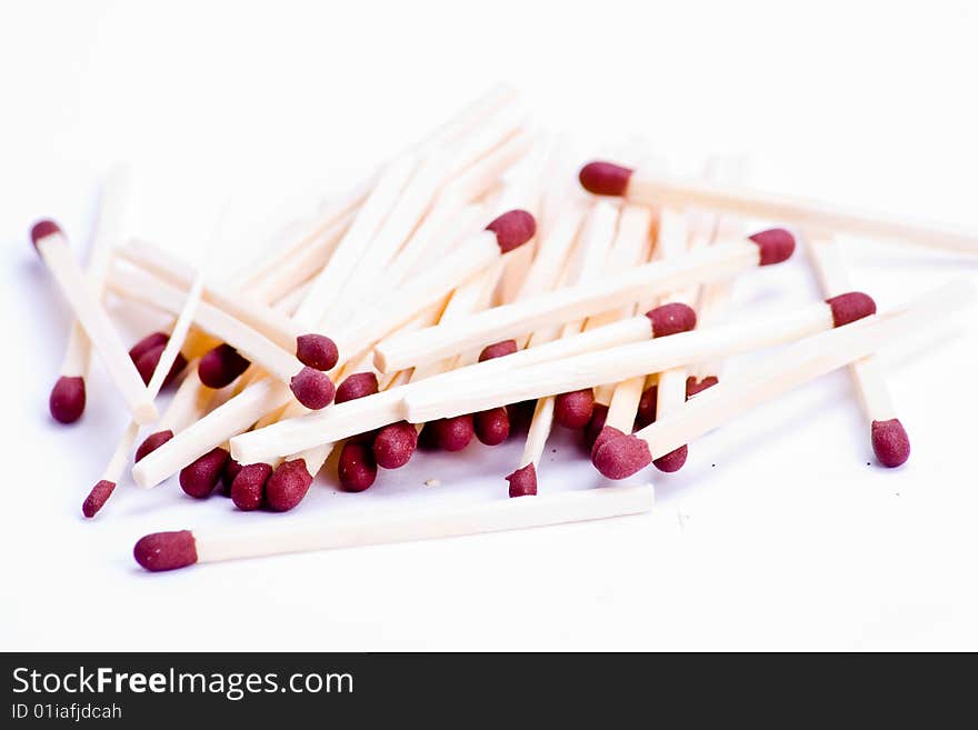 A pile of matches with red tips over white