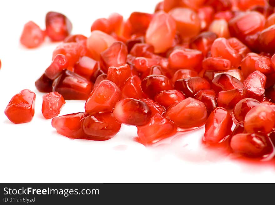 Bright and fresh Pomegranate seeds on white