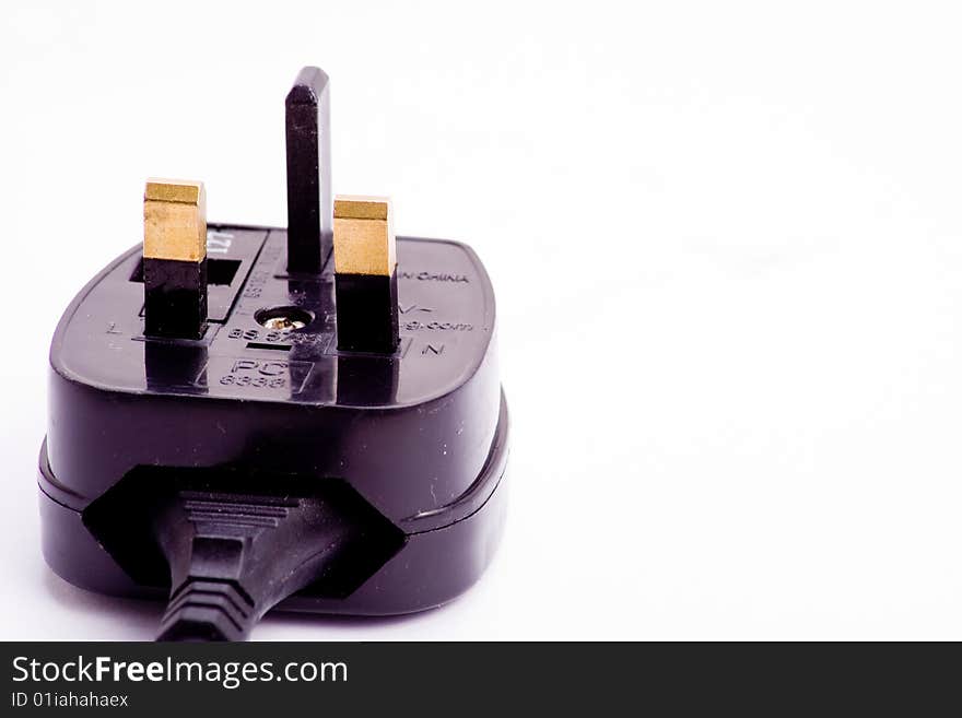 A black electrical plug isolated over white. A black electrical plug isolated over white