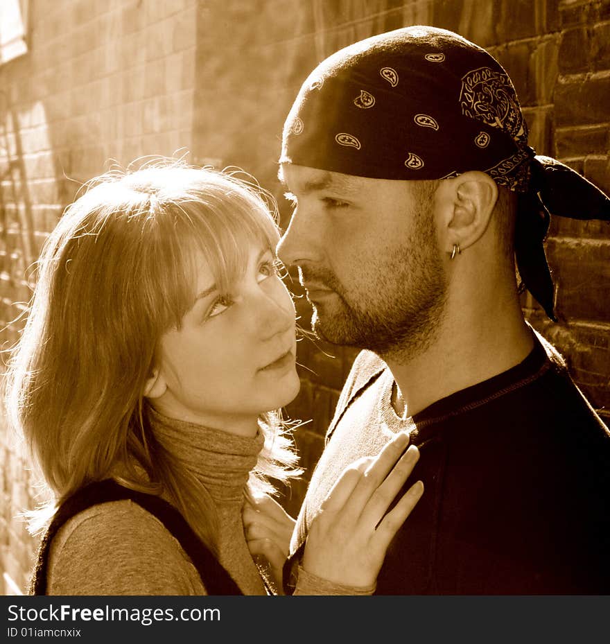 Young Couple Against A Brick Wall